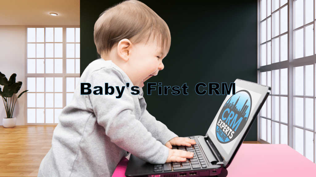A baby banging on a laptop in an office with the CRM Experts Logo on it, under the heading "Baby's First CRM"
