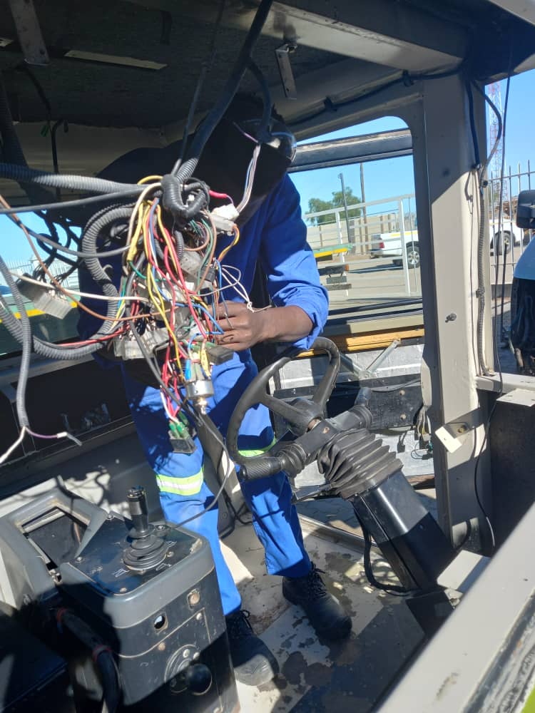 Field service technician repairing air conditioning and refrigeration equipment on site